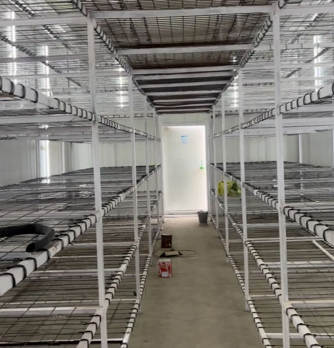 An empty climate-controlled grow room with tiered racks, ready for its first crop